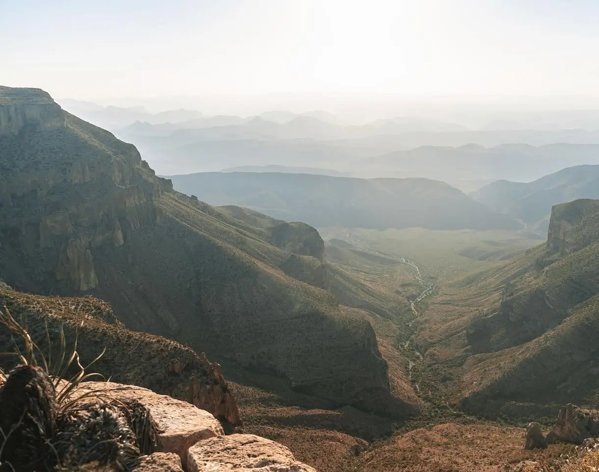 Hunters glassing a Texas Hill Country canyon at first light